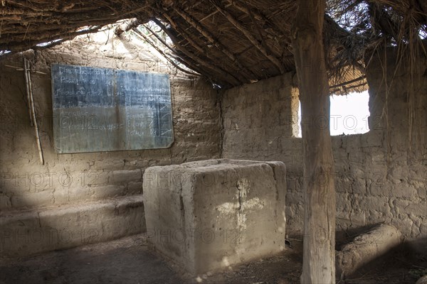 A simple earth building serves as both a school and church