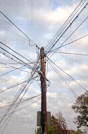 Telephone pole with tangled cables