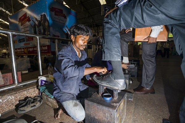 Shoeshine working inside Churchgate Railway Station