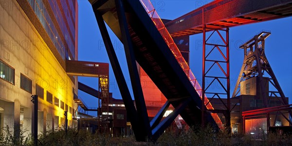 Illuminated gangway to the Ruhr Museum at the Zeche Zollverein Coal Mine Shaft XII with the headframe