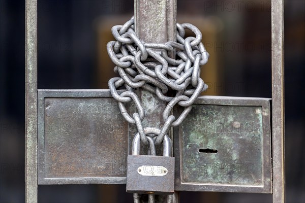 Chain with padlock on an iron gate