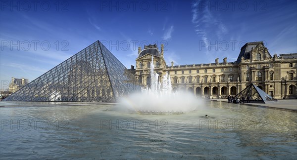 Fountains in front of the entrance pyramid of the Louvre Museum designed by architect IM Pei