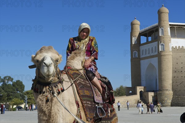 Local tourist on a camel in front of the Ark fortress
