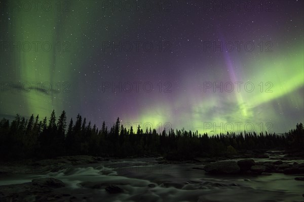 Northern lights or aurora borealis over river