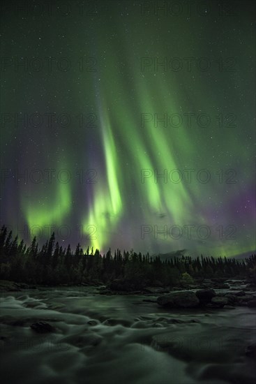 Northern lights or aurora borealis over river