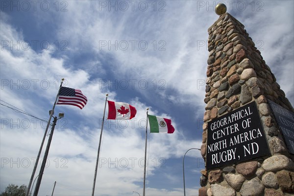 Monument to mark the geographical center of North America and the flags of the US