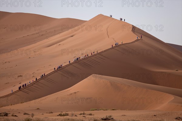 Tourists climbing the Sossusvlei Dunes