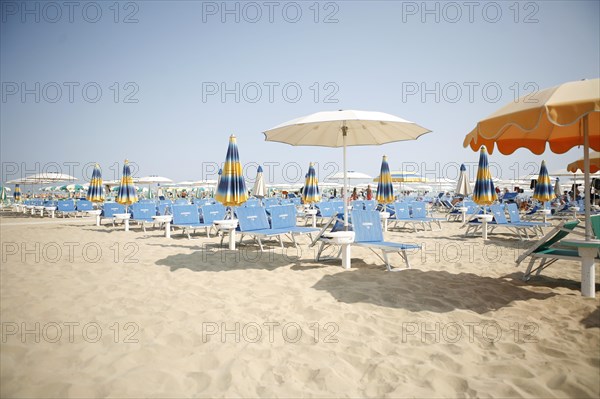 Empty beach with parasols and sun beds