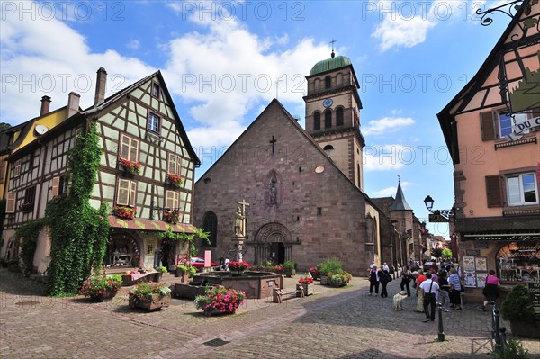 Half-timbered house and fountain in front of the Church of Sainte-Croix on the Rue du General de Gaulle