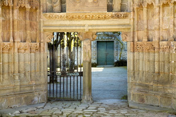 Carved stone portal gate to the courtyard of the Abbey of Moutier-d'Ahun