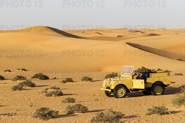 Land rover from the 50s before sand dunes