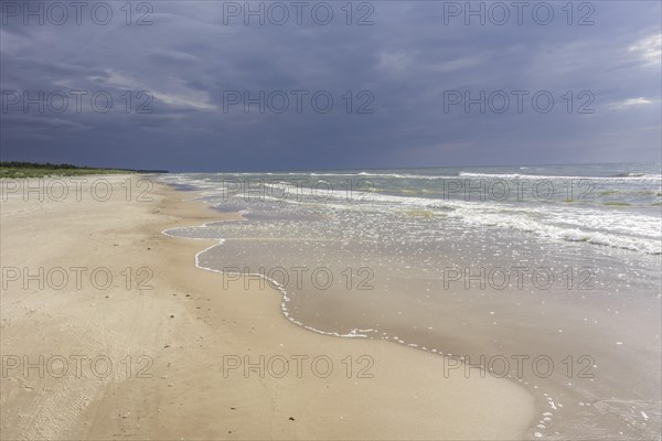 Sandy beach on the Baltic sea with storm clouds