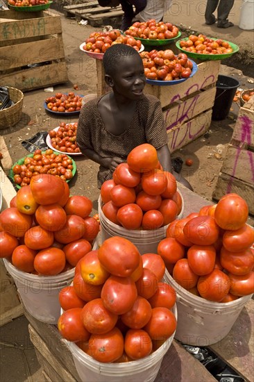 Child selling imported tomatoes