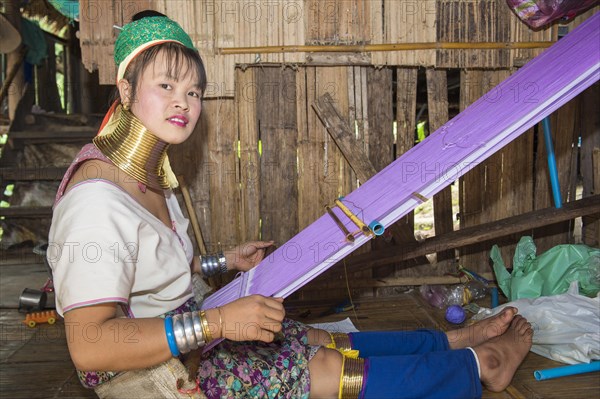 Long-necked woman weaving