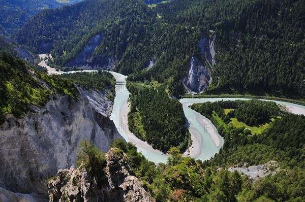 River bend of the Vorderrhein with railway bridge of the Rhaetian Railway