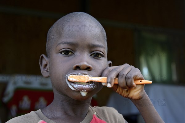 Young boy brushing his teeth