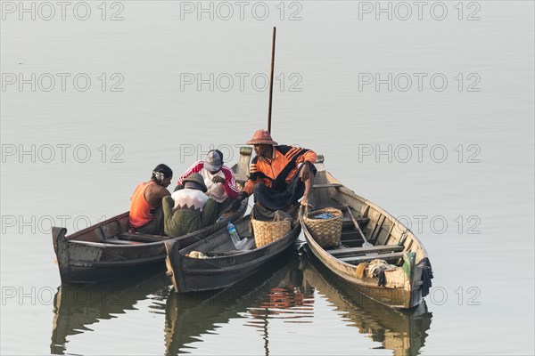 Fishermen in their boats in the morning light