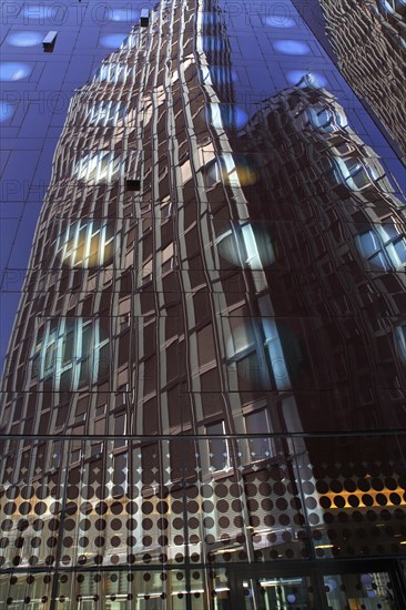 Tanzende Turme office building reflected in the facade of the Arcotel Onyx Hotel