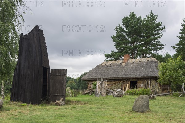 House in an old fishing village and part of a wooden boat that serves as a smokehouse