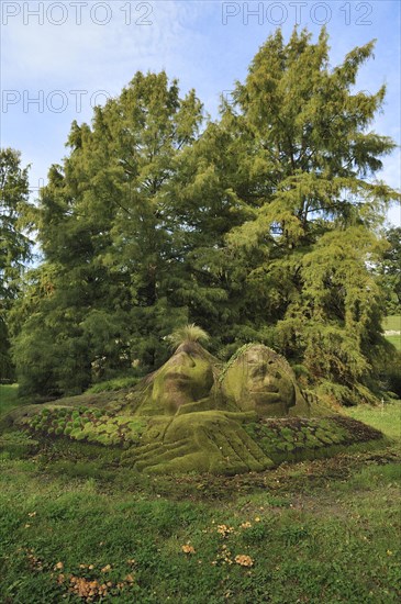 Stone statues overgrown with moss