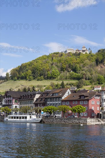 Townscape on the bank of the Rhine River with a boat landing and Burg Hohenklingen Castle