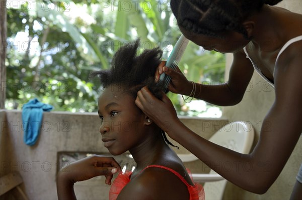 Young women braiding their hair