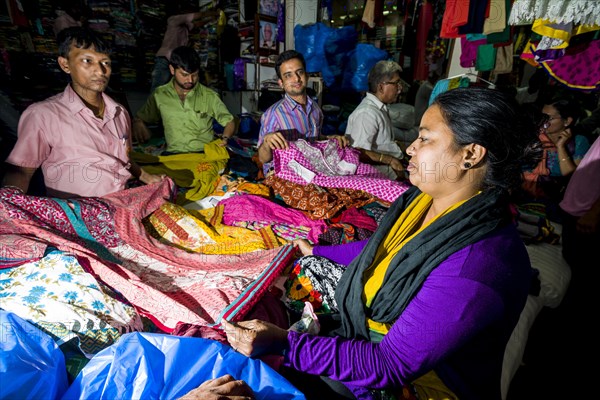 A woman is buying material at Mangaldas Market