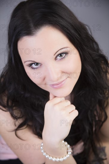 Smiling young woman wearing a pearl bracelet