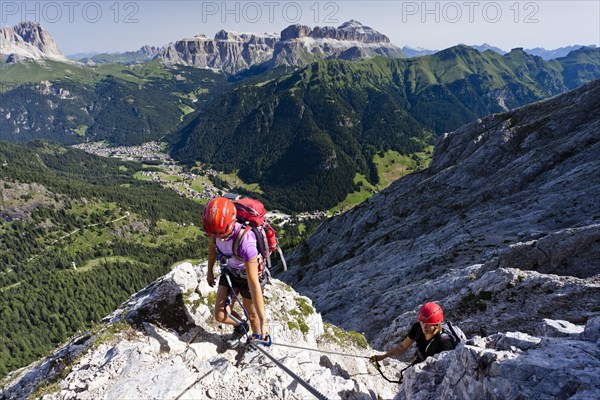 Mountain climbers ascending the Via Ferrata dei Finanzieri climbing route on Colac Mountain in Val di Fassa valley