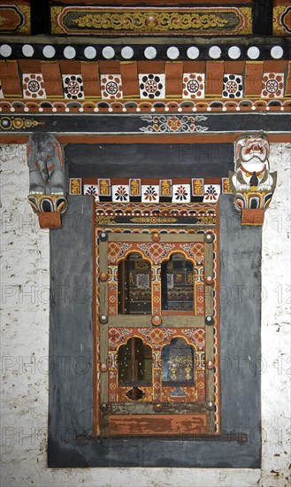 Window in typical Bhutanese style in the Trashi Chhoe Dzong monastic fortress