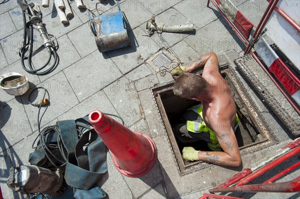 Telephone engineer replacing old copper cables with fibreglass lines