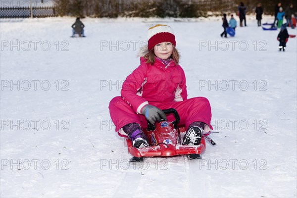 Girl sitting on a sled