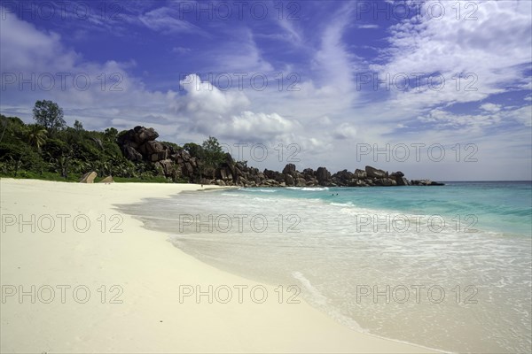 Sandy beach with the rock formations typical for the Seychelles