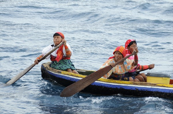 Kuna Indian women in a dugout canoe