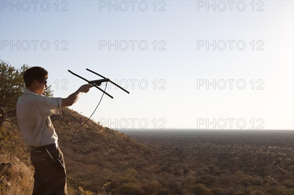 Man is radio tracking a leopard at the Okonjima Lodge