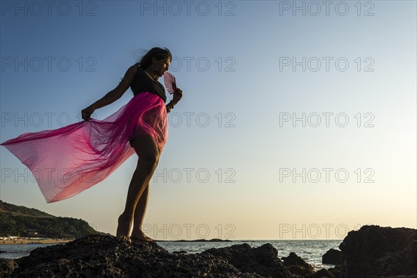 Young Indian woman wearing a pink skirt