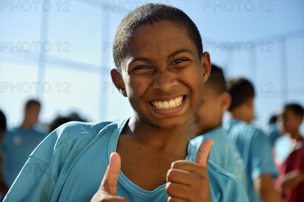 Boy making thumbs-up gesture