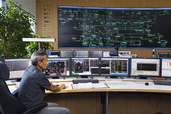 Shift supervisor Hans-Peter Polzer sitting at his work station in the Transmission Control Center