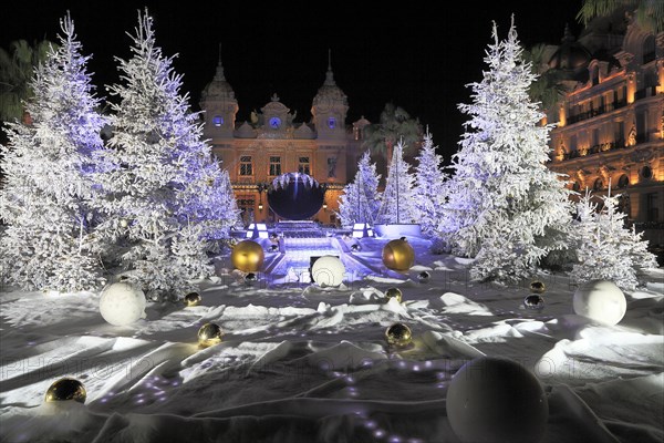 Christmas decorations with white fir trees on the square in front of the Monte Carlo Casino