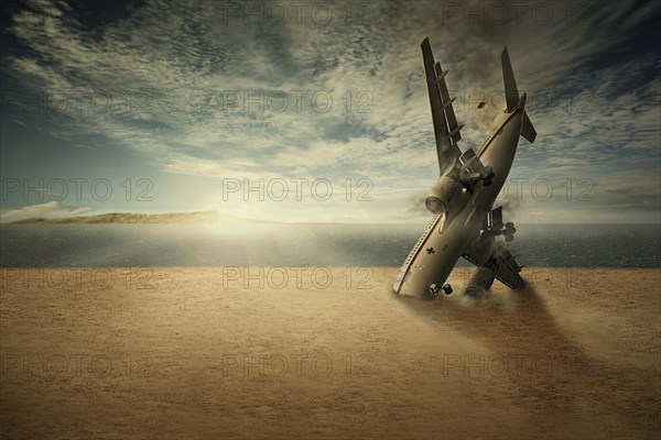 A crashed plane with the nose stuck in the sand on a beach