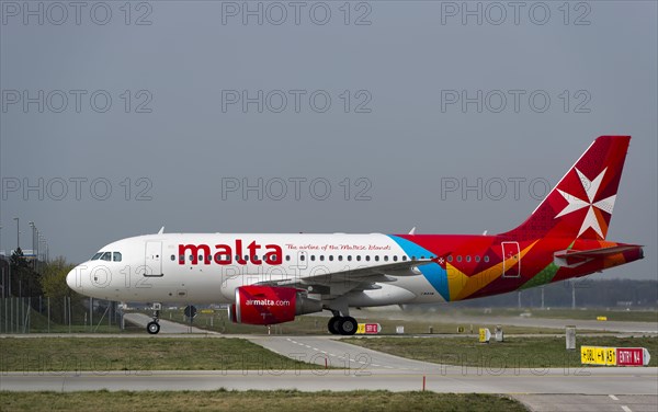 An Airbus A319-112 of the airline AIR MALTA rolls to its parking position at Munich Airport