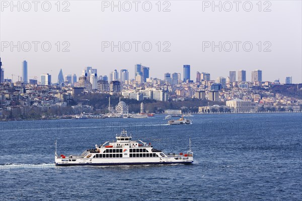 Car ferry on the Bosphorus and the districts of Besiktas and Sisli with Dolmabahce Palace