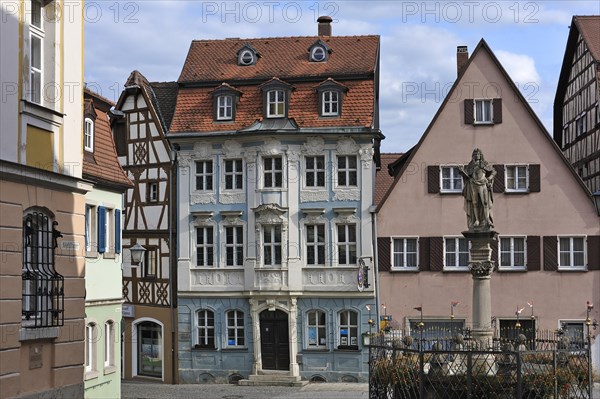 Schoner Brunnen fountain with a Rococo building at back