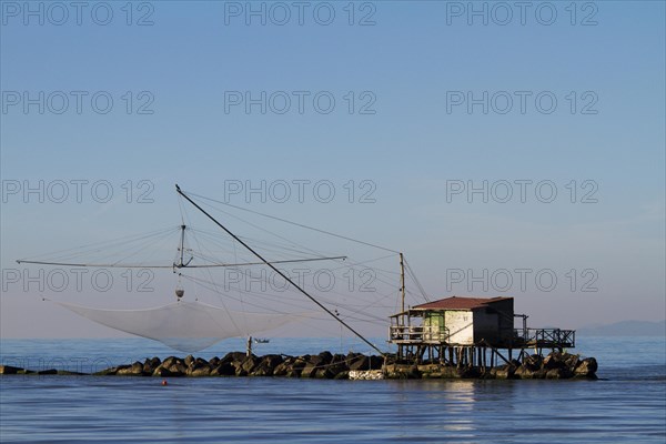 Fisherman's house with a net over the sea in Marina di Pisa