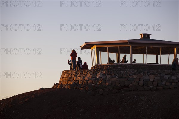 Tourists awaiting the sunrise on the summit of the Haleakala volcano