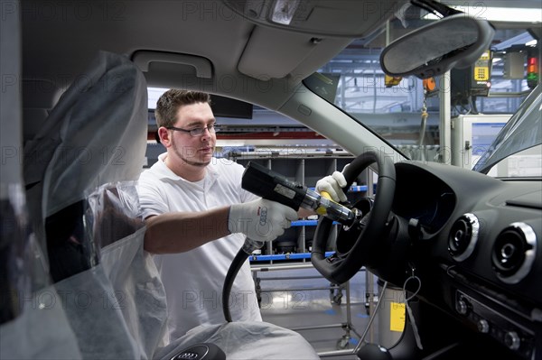 Man working on the production line of the Audi A3 at the Audi plant