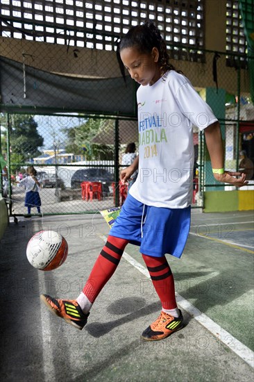 Girl juggling a football