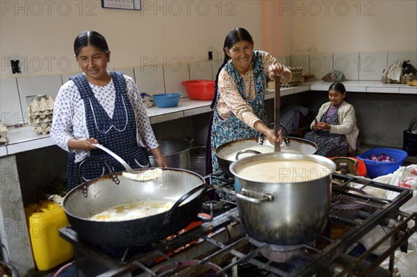 Cooks working in the kitchen of a boarding school