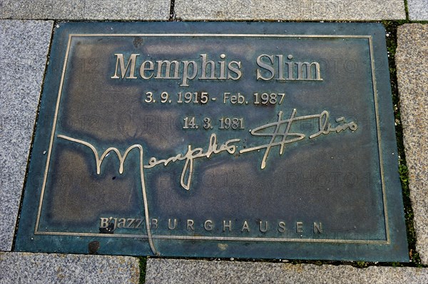 Plaque for the jazz musician Memphis Slim in the pavement of the 'Street of Fame'