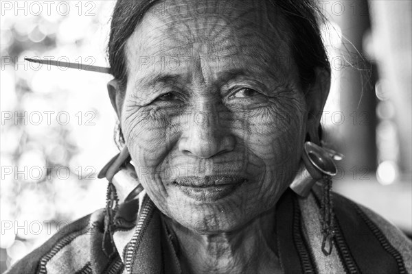 Woman with a traditional facial tattoo and ear jewelry